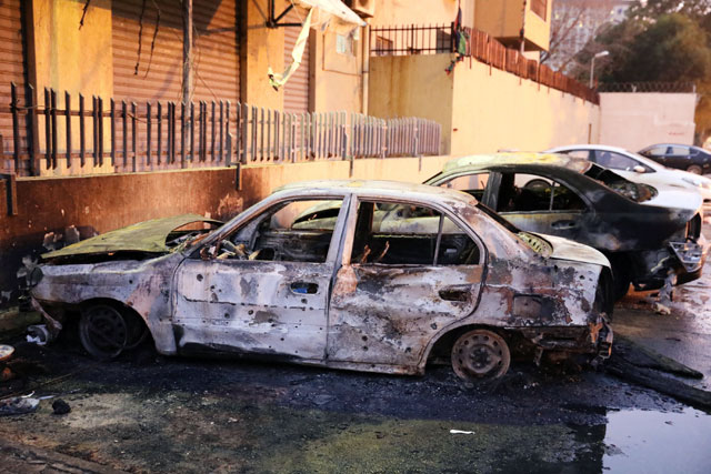 Burned cars are seen at the site of the headquarters of Libya’s foreign ministry after suicide attackers hit in Tripoli, Libya, on Tuesday (Reuters photo)