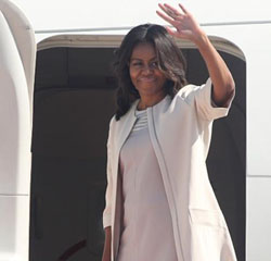 US first lady Michelle Obama waves as she departs from Hamad airport after a short visit to Doha, Qatar, Friday (AP photo)