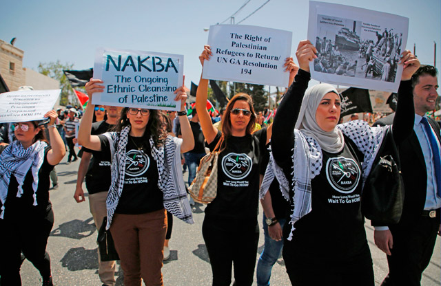Palestinian protesters take part in a demonstration marking the 69th anniversary of Nakba, which remember those displaced at the time of the 1948 founding of Israel, near the Jewish settlement of Beit El, near the West Bank city of Ramallah, on Monday (AFP photo)