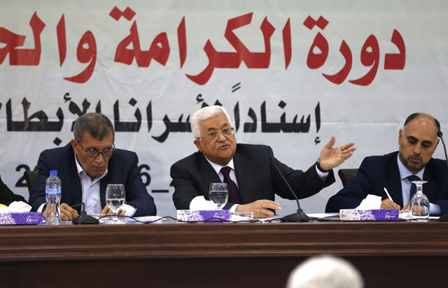 Palestinian President Mahmoud Abbas (centre) speaks to senior members of his Fateh Party during a press conference in the Israeli occupied West Bank city of Ramallah on Thursday (AFP photo)