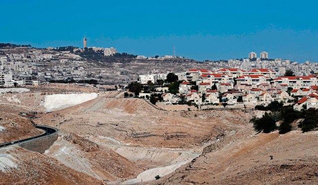 This photo taken from the Israeli settlement of Qedar shows the West Bank Israeli settlement of Maale Adumim (foreground right), a few kilometres from East Jerusalem (background)  on October 26 (AFP photo)