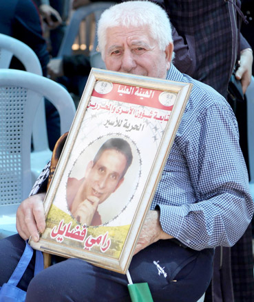 Palestinians hold the pictures of Palestinian prisoners, who are on hunger strike in Israeli jails, during a solidarity demonstration at Yasser Arafat Square in Ramallah, West Bank, on Wednesday (Anadolu Agency photo)