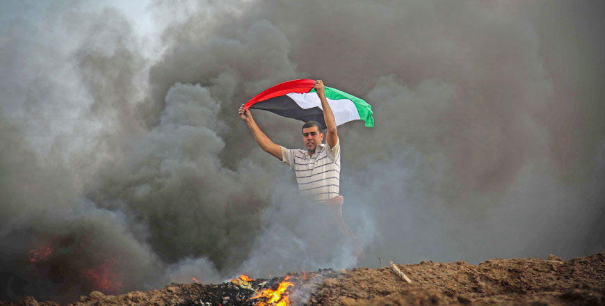 A protester waves a Palestinian flag during a protest against the US decision to recognise  Jerusalem as Israel’s capital in Khan Younis district of Gaza City, Gaza, on Friday (Anadolu Agency photo)