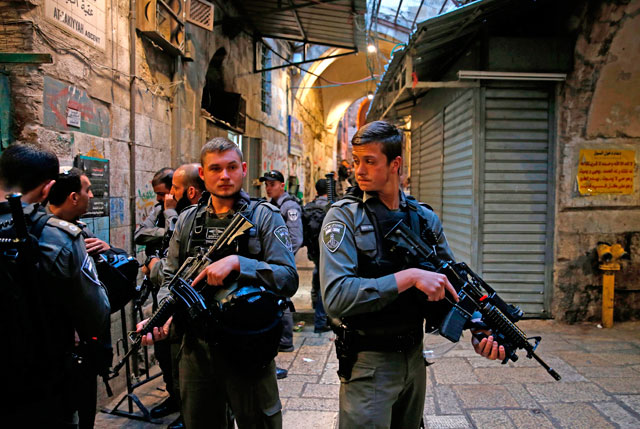 Israeli forces stand guard at the site of a stabbing attack carried out by a Palestinian in Jerusalem's Old City on Sunday (AFP photo)