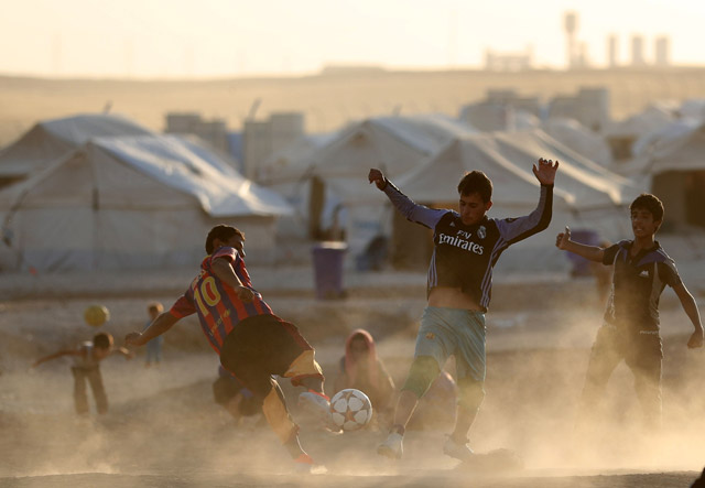 Displaced Iraqis play football during the Muslim holy month of Ramadan at Al Khazir camp for the internally displaced, located between Erbil and Mosul, on Monday (AFP photo)