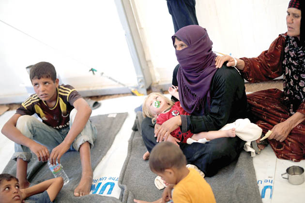 Displaced Iraqi people are treated in a field hospital at the Hasansham U2 camp, where more than 300 people fell ill in a mass outbreak of food poisoning in Al Khazer, east of Mosul, Iraq, on Tuesday (Reuters photo)