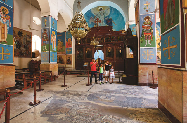 In this undated photo, visitors look at the mosaic map at Greek Orthodox St George’s Church in Madaba  (Photo courtesy of Ministry of Tourism and Antiquities)