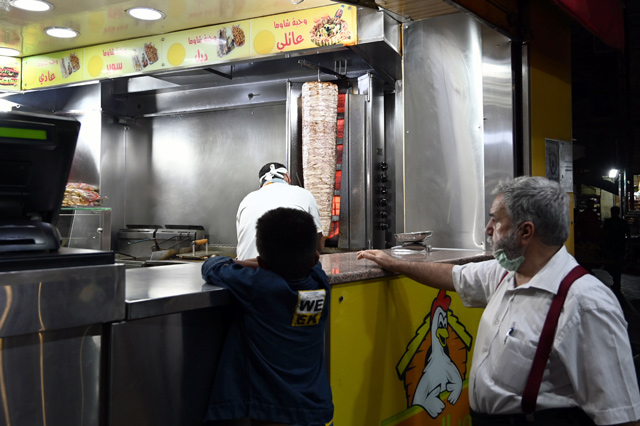 A customer waits for his order at a restaurant in Amman in this recent photo (Photo by Amjad Ghsoun)