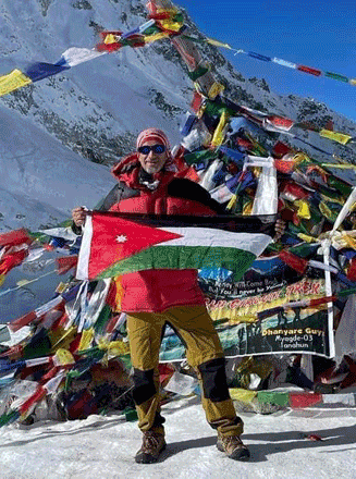 Abdel Rahim Arjan poses for a photo with the Jordanian national flag at the summit of the Himalayan Manaslu Larkya Pass Trek  (Photo courtesy of Abdel Rahim Arjan)