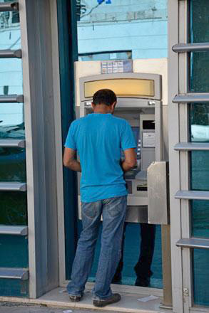 A man is seen withdrawing money from an ATM in Amman in this file photo (JT file photo)