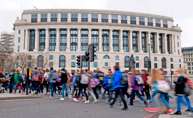 Pedestrians cross the road in front of the Unilever building in central London on Thursday (AFP photo)
