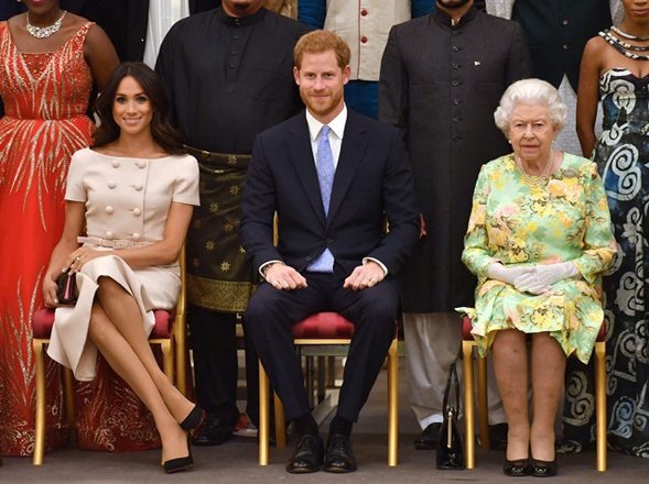 In this file photo taken on June 26, 2018 (left to right) Meghan, Duchess of Sussex, Britain's Prince Harry, Duke of Sussex and Britain's Queen Elizabeth II pose for a photo during the Queen's Young Leaders Awards Ceremony on June 26, 2018 at Buckingham Palace in London (AFP photo)