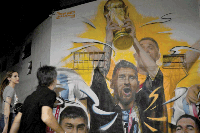 A mural by artist Maxi Bagnasco depicting Argentina's captain and forward Lionel Messi raising the FIFA World Cup Trophy next to his teammates after winning the Qatar 2022 World Cup tournament is seen in Buenos Aires on December 22 (AFP photo)