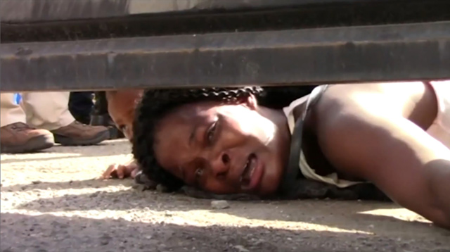 Video grab of a desperate migrant woman from Haiti asking reporters for help, underneath a fence of a migration centre in Tapachula, Chiapas state, Mexico, on Tuesday (AFP photo)