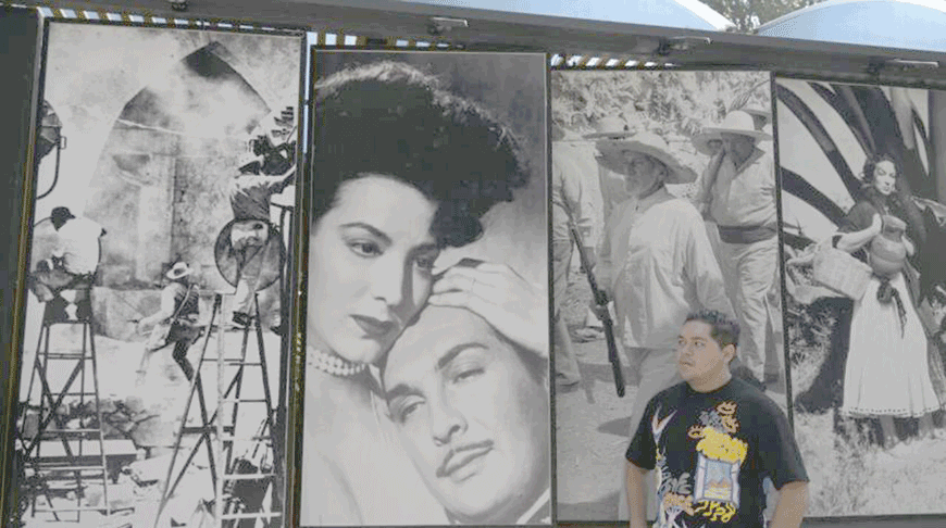 A man is seen next to photographs of actors from the golden age of Mexican cinema, at the Churubusco studios in Mexico City (AFP photo)