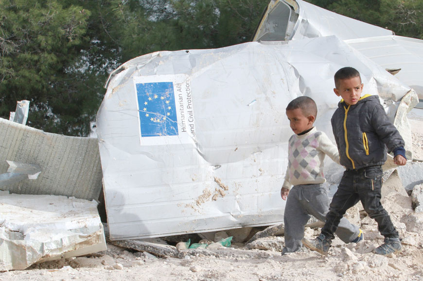 Palestinian boys walk past the remains of their family’s dwelling, which was funded by the EU’s humanitarian arm, after it was demolished by Israeli forces, near the West Bank village of Al Eizariya, east of Jerusalem, on Thursday (Reuters photo)