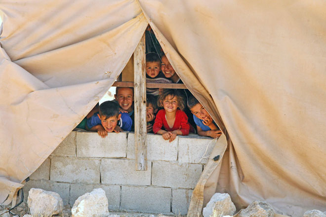 Palestinian children look out from a window in the Palestinian village of Khirbet Zanuta, located in the hills south of the West Bank city of Hebron, on May 30 (AFP photo)