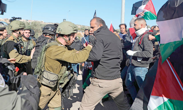 A Palestinian protester confronts an Israeli soldier during a demonstration near the West Bank village of Qalqilya on Monday (AFP photo)