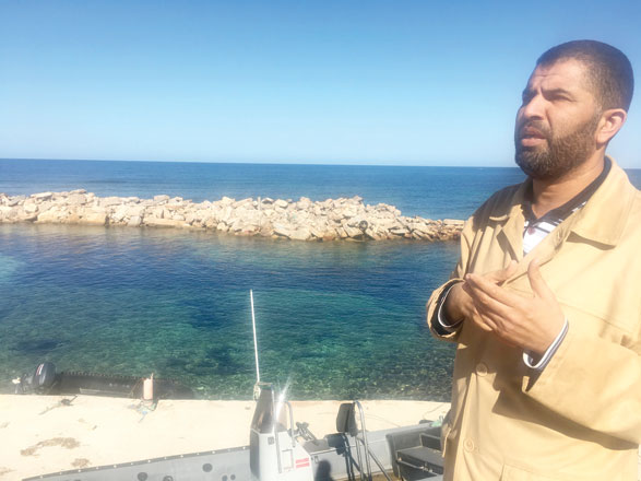 Coastguard official Ayman  Al Dabbashi is seen on the seafront at the Libyan city of Sabratha, Libya, on November 21 (Reuters photo)