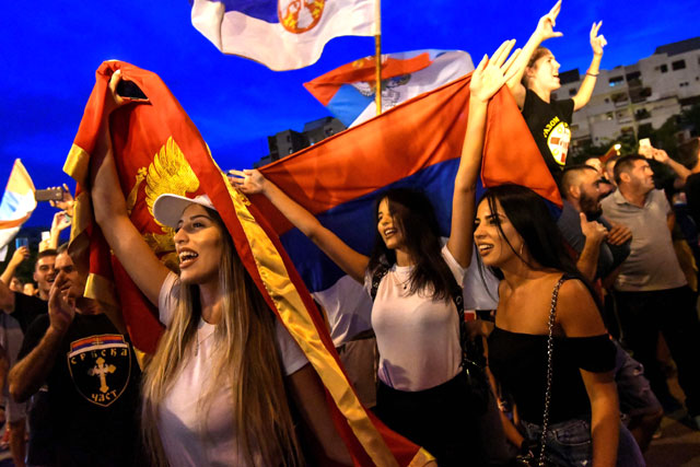 Opposition supporters celebrate on the streets after the general elections in Podgorica, Montenegro, on Monday (AFP photo)
