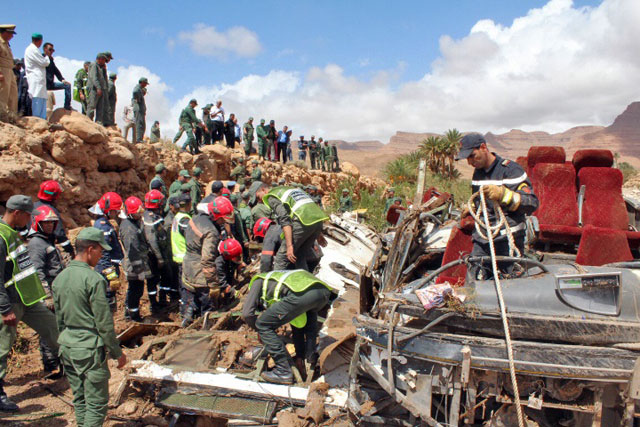 Members of the security forces search for bodies in the wreckage of bus at the banks of the Damchan River near the city of Errachidia, in El Khank region in southern Morocco, on Sunday (AFP photo)