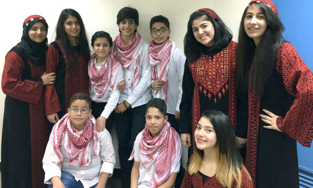Participants pose for a photo during the final concert of a project by the National Music Conservatory, supported by USAID, at Al Hussein Cultural Centre in Amman last week (Photo by Muath Freij)
