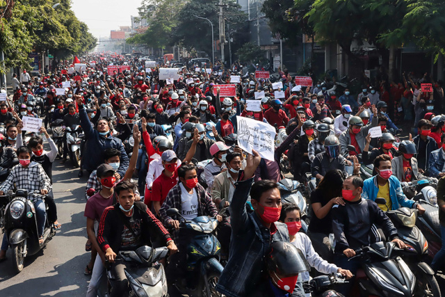   Protesters hold posters during a demonstration against the military coup near the royal palace in Mandalay, on Sunday (AFP photo)