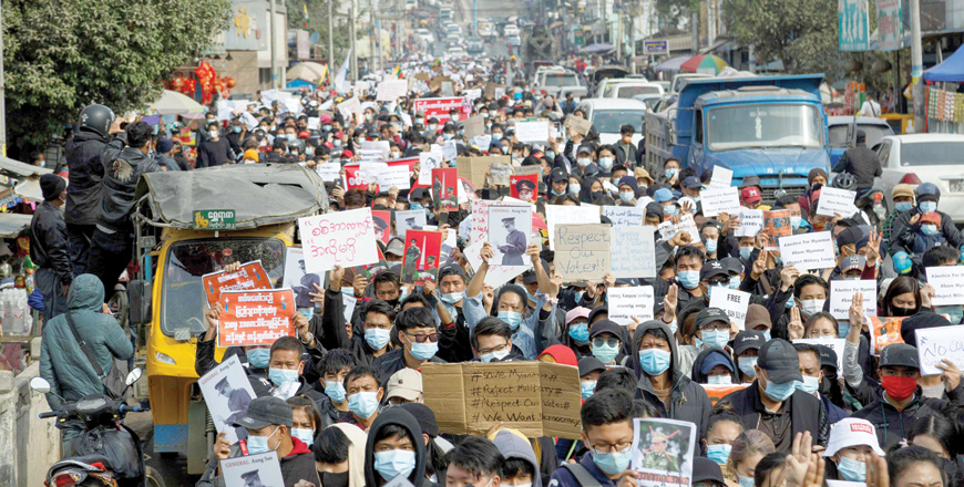 People take part in a demonstration against the February 1 military coup, along a street in the town of Muse in Shan state, near the China-Myanmar border on Monday (AFP photo)