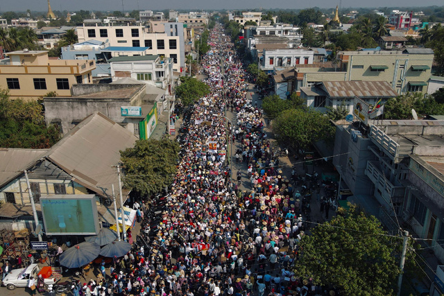 This aerial photo shows protesters marching on a road during a demonstration against the military coup in Shwebo in Myanmar's Sagaing region on Saturday (AFP photo)