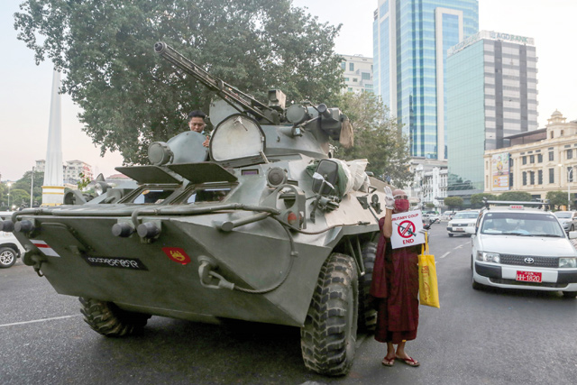 An armoured vehicle drives past the Sule Pagoda, following days of mass protests against the military coup, in Yangon on Sunday (AFP photo )