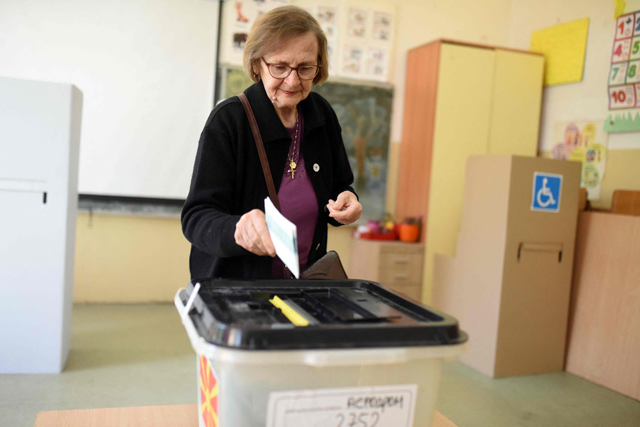 A woman casts her ballot to vote in the first round of the presidential elections, at a polling station in Skopje on Wednesday (AFP photo)