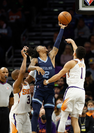 Ja Morant #12 of the Memphis Grizzlies attempts a shot over Devin Booker #1 and Chris Paul #3 of the Phoenix Suns during the first half of the NBA game at Footprint Centre on Tuesday in Phoenix, Arizona (AFP photo)