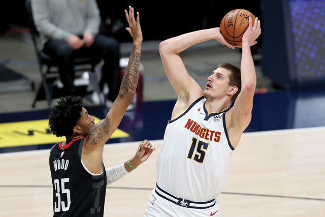 Nikola Jokic #15 of the Denver Nuggets puts up a shot over Christian Wood #35 of the Houston Rockets in the first quarter at Ball Arena on Monday in Denver, Colorado (AFP photo)