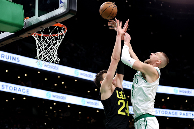 Walker Kessler #24 of the Utah Jazz fouls Kristaps Porzingis #8 of the Boston Celtics during the second quarter at TD Garden on Saturday in Boston, Massachusetts (AFP photo)