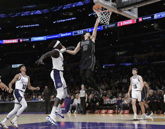 Yuta Watanabe #18 of the Brooklyn Nets scores a basket against Wenyen Gabriel #35 of the Los Angeles Lakers during the first half of the game at Crypto.com Arena on Sunday in Los Angeles, California (AFP photo)