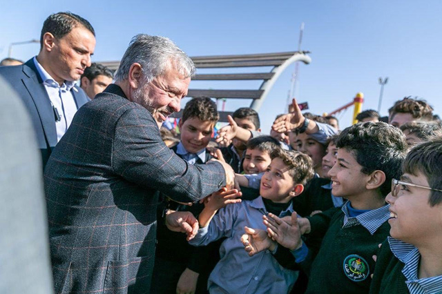 His Majesty King Abdullah interacts with children during the inauguration of the King Abdullah II Park, established in Mugabalein area, on Wednesday  (Photo courtesy of Royal Court)