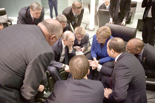 Egyptian President Abdul Fattah Al Sisi (right), Russian President Vladimir Putin (2nd left), German Chancellor Angela Merkel (2nd right) and French President Emmanuel Macron (front) talk on the sidelines of a Peace summit on Libya in Berlin on Sunday (AFP photo)