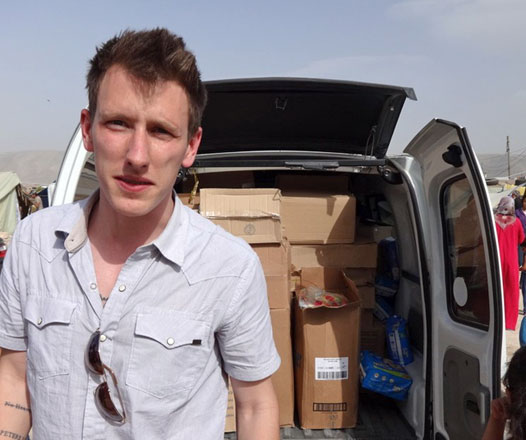 This file photo released by the Kassig Family on October 4, 2014, shows Peter Kassig with a truck, taken somewhere along the Syrian border between late 2012 and fall 2013, as Speical Emergency Response and Assistance was delivering supplies to refugees (AFP photo)