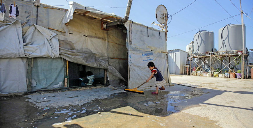   Syrian children are photographed at a refugee camp in the village of Mhammara in the northern Lebanese Akkar region on Saturday (AFP photo)