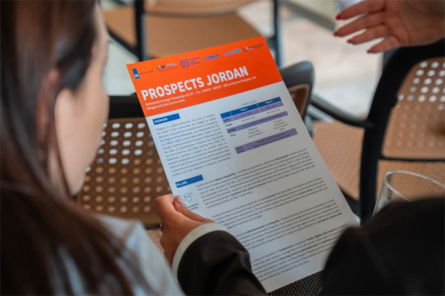 Attendees of a ceremony to launch PROSPECTS read a brochure about the global partnership progarmme (Photo courtesy of Embassy of The Netherlands)