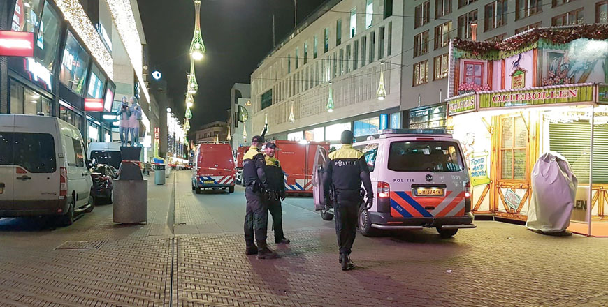 Policemen stand near a police cordon at the Grote Marktstraat, one of the main shopping streets in the centre of the Dutch city of The Hague, after several people were wounded in a stabbing incident, on Friday (AFP photo)