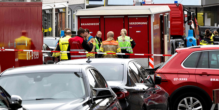Emergency responders stand behind a security cordon near their vehicles following a hostage situation at Cafe Petticoat in Ede, on Saturday (AFP photo)