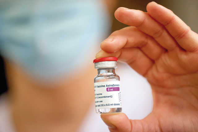 In this file photo taken on February 8 a member of the medical staff holds a vial of the AstraZeneca/Oxford COVID-19 vaccine at the South Ile-de-France Hospital Group (Groupe Hospitalier Sud Ile-de-France), in Melun, on the outskirts of Paris  (AFP photo)