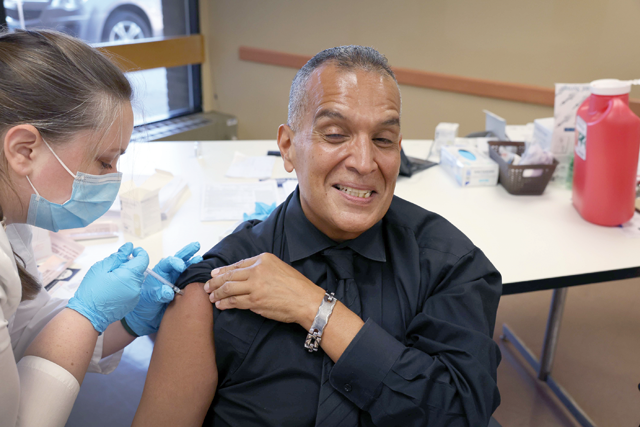 Felipe Sanchez gets a COVID-19 booster shot from pharmacist Patricia Pernal during an event hosted by the Chicago Department of Public Health at the Southwest Senior Centre on Friday in Chicago, Illinois (AFP photo)