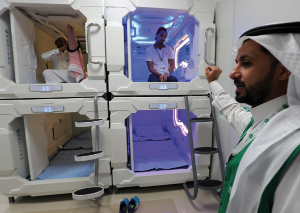 Saudi men are photographed inside sleep pods in Mecca on Thursday (AFP photo)