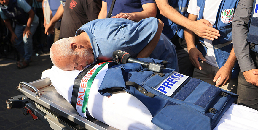 A relative bids farewell during the funeral of Palestine TV journalist Mohamed Abu Hatab and 11 family members, the day after they were killed in an Israeli bombardment of Khan Yunis in November 2023 (AFP photo)
