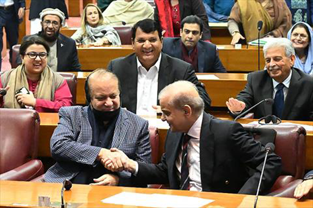 This handout photograph taken and released on Sunday by the Pakistan national assembly, shows Pakistan’s former prime minister Nawaz Sharif and leader of the Pakistan Muslim League Party greeting his younger brother and newly-elected Pakistan’s Prime Minister Shehbaz Sharif at the Parliament House in Islamabad (AFP photo/Pakistan national assembly)