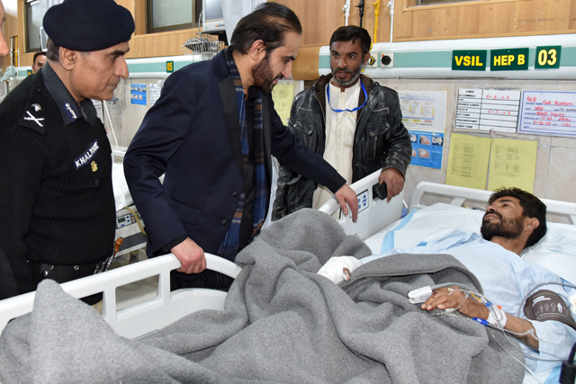 Chief Minister of Balochistan Mir Abdul Qudoos Bizenjo speaks with a policeman receiving treatment, after he was injured in a suicide bomb attack in Kachhi district, during his visit to a hospital in Quetta on Monday (AFP photo)