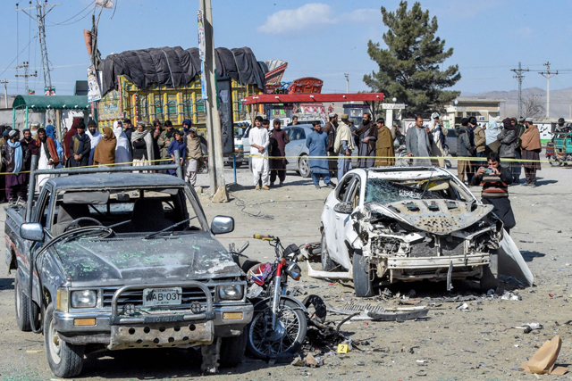 People gathered at the site of a bomb blast outside the office of an independent candidate in Pishin district, around 50 kilometres from Quetta on Wednesday, on the eve of Pakistan’s national elections (AFP photo)