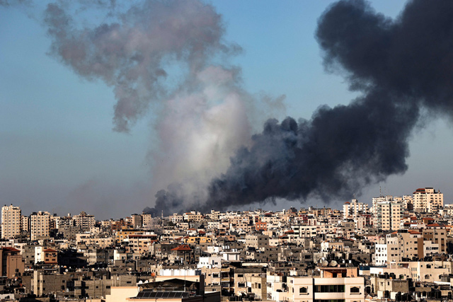 Plumes of smoke rise above buildings hit by Israeli airstrikes in Gaza City, on Saturday (AFP photo)